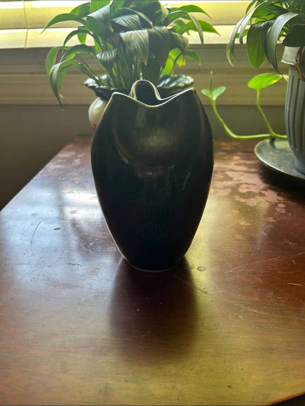 Beautiful Dark ceramic pinch vase with an organic, folded rim